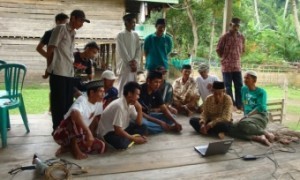 Farmers from Bone, South Sulawesi, watch a video on direct seeding using a drum seeder. The video was made by farmers in Southeast Sulawesi. (Photo: Trina Leah Mendoza, IRRI)