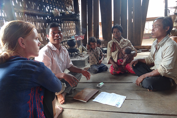 CORNELL PHD candidate Alice Beban (left) used her ARFUSA travel grant to enhance her field research in Cambodia. Here, she interviews a Cambodian farm family about their land security. (Photo: Alice Beban)