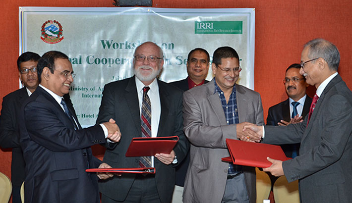 INDIA, BANGLADESH, Nepal, and IRRI seal the deal. From left, S.M. Nazmul Islam, Bangladesh; Robert Zeigler, IRRI director general; Jaya Mukunda Khanal, Nepal; and Ashish Bahuguna, India.