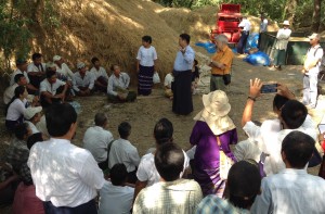 Dr. Myo Aung Kyaw (center, standing), IRRI consultant, explains to farmers how the flatbed dryer works. Dr. Kyaw also spearheaded the training of dryer operators to ensure proper use and maintenance. Photo by Chris Cabardo.